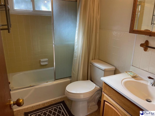 full bathroom featuring tile patterned floors, toilet, tile walls, vanity, and shower / bath combo