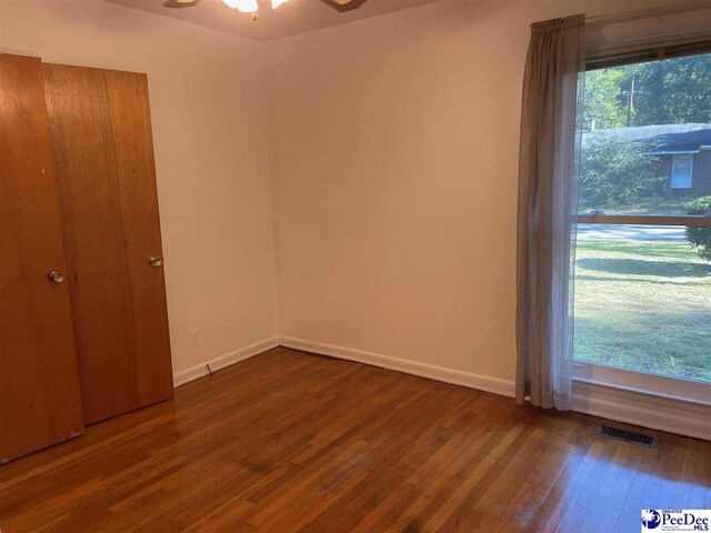 unfurnished bedroom featuring dark wood-type flooring