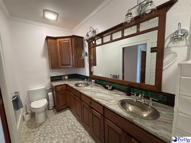 bathroom featuring crown molding, vanity, and toilet