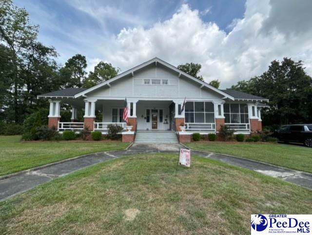 view of front of house featuring a front lawn and a porch