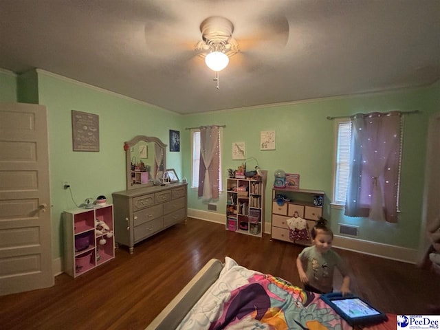 bedroom featuring ceiling fan, ornamental molding, and dark hardwood / wood-style flooring