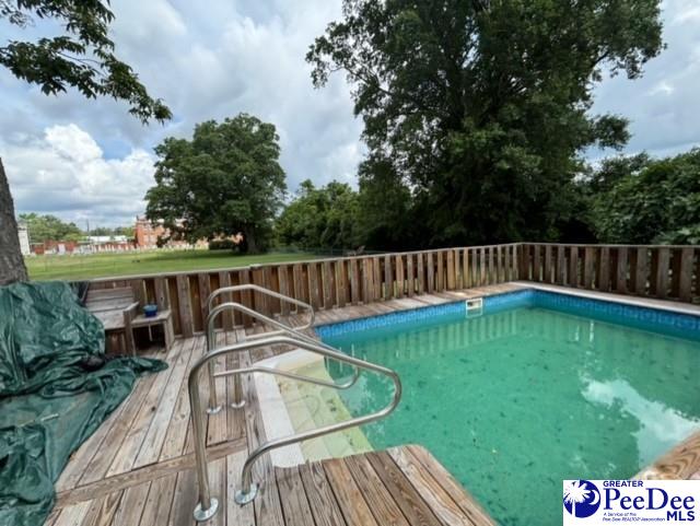 view of swimming pool featuring a wooden deck