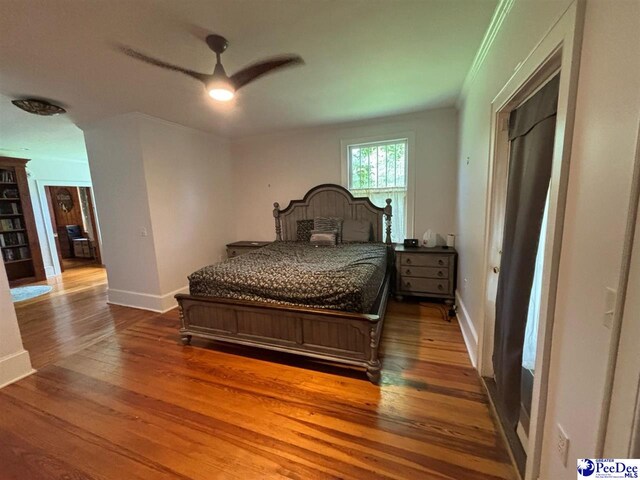 bedroom with hardwood / wood-style flooring and ceiling fan