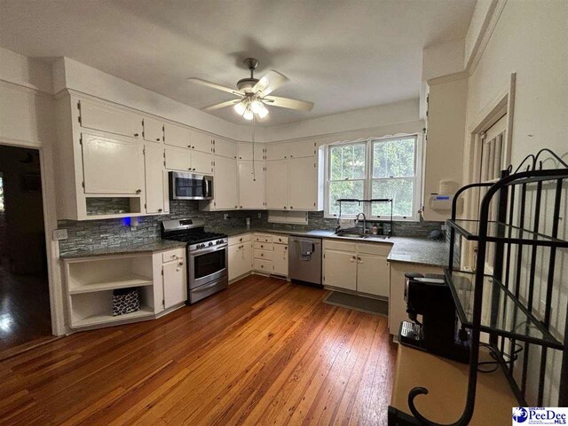 kitchen with white cabinetry, appliances with stainless steel finishes, dark hardwood / wood-style floors, and sink