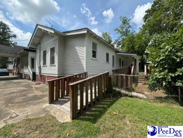 view of side of property with a yard