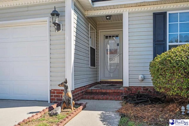 view of exterior entry with a garage