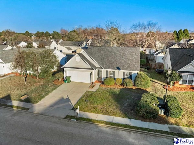 view of front of home featuring a garage and a front lawn