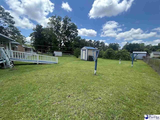 719 Parrish Dr, Mullins, SC 29574 - view of yard featuring a shed and a wooden deck