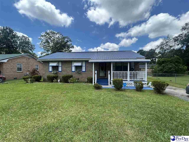 719 Parrish Dr, Mullins, SC 29574 - view of front facade with a porch, a metal roof, and brick siding