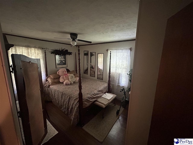 719 Parrish Dr, Mullins, SC 29574 - bedroom with wood finished floors, ceiling fan, and a textured ceiling