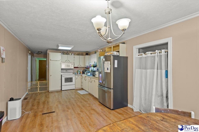 kitchen with white appliances, ornamental molding, a chandelier, light wood-style flooring, and a textured ceiling