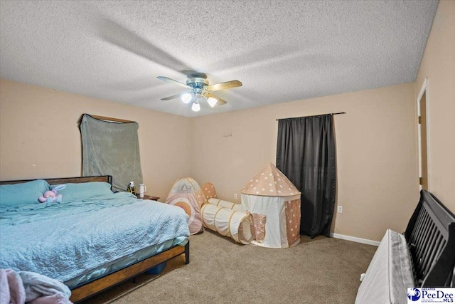 bedroom featuring carpet floors, a ceiling fan, and a textured ceiling