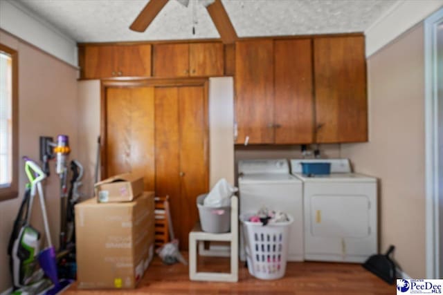 clothes washing area with cabinet space, washer and dryer, ceiling fan, and wood finished floors