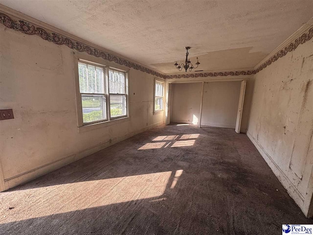 207 W Smith Ave, Darlington, SC 29532 - carpeted empty room with a textured ceiling and a chandelier