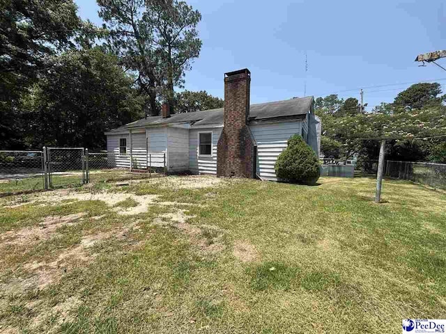 207 W Smith Ave, Darlington, SC 29532 - back of property with a gate and a chimney