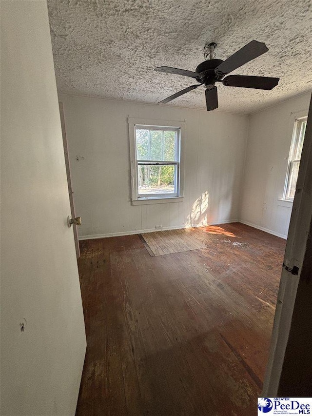 207 W Smith Ave, Darlington, SC 29532 - unfurnished room featuring wood-type flooring, ceiling fan, baseboards, and a textured ceiling
