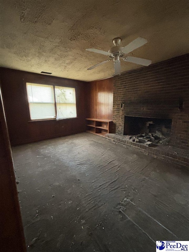 207 W Smith Ave, Darlington, SC 29532 - unfurnished living room with ceiling fan, a brick fireplace, and a textured ceiling
