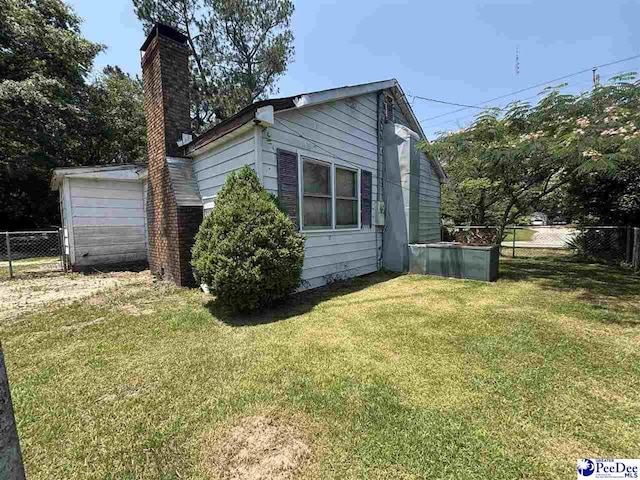 207 W Smith Ave, Darlington, SC 29532 - view of side of home featuring a chimney and a garage