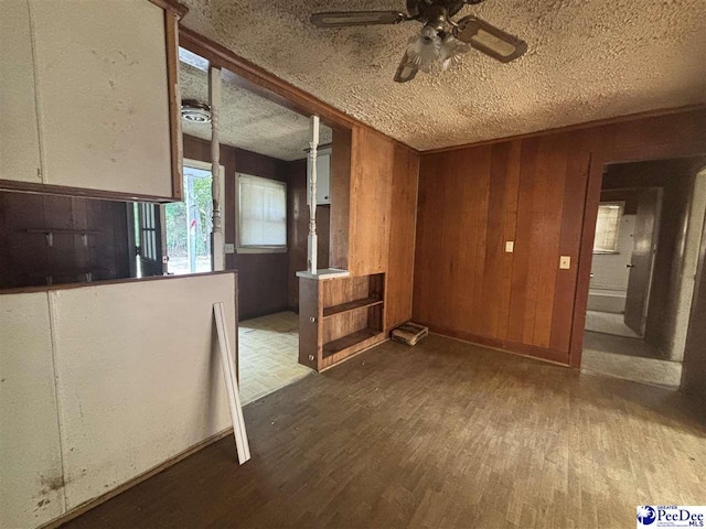 207 W Smith Ave, Darlington, SC 29532 - empty room featuring a textured ceiling, wood finished floors, a ceiling fan, and wooden walls