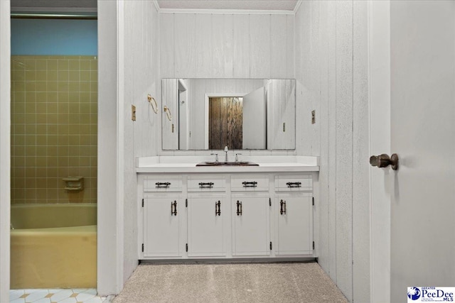 bathroom with vanity, ornamental molding, and wooden walls