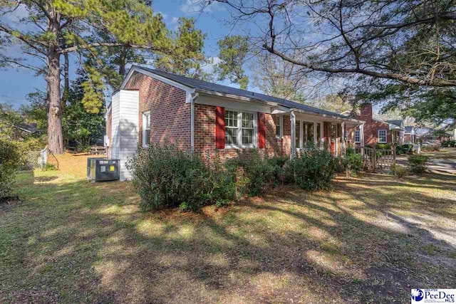 exterior space with cooling unit and a front yard