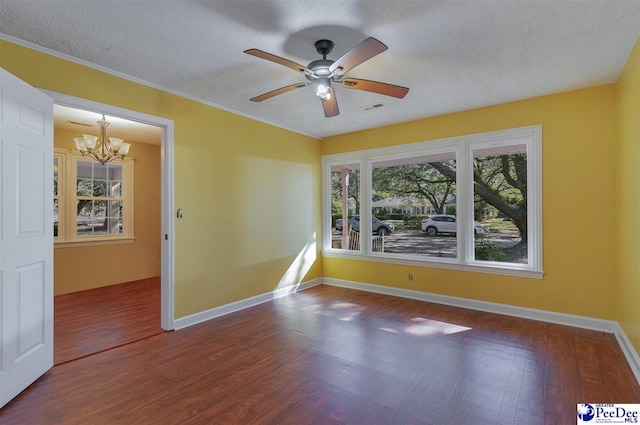 empty room with wood-type flooring, ceiling fan with notable chandelier, and a textured ceiling