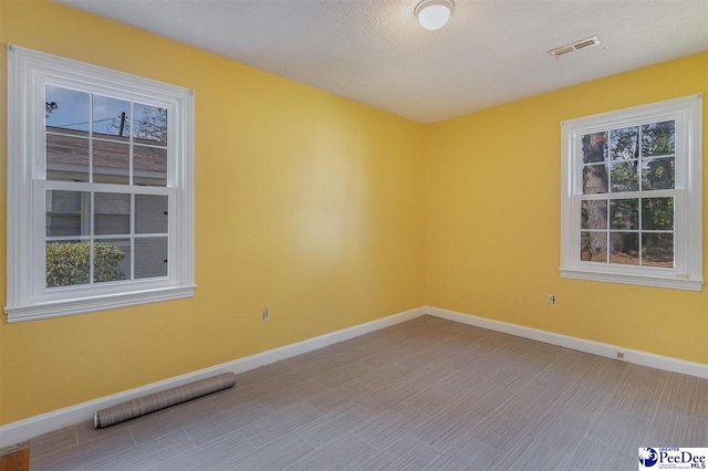 spare room featuring a textured ceiling