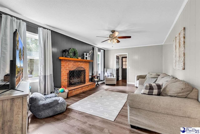 108 Wyandot St, Darlington, SC 29532 - living area with ornamental molding, a ceiling fan, wood finished floors, a brick fireplace, and wood walls