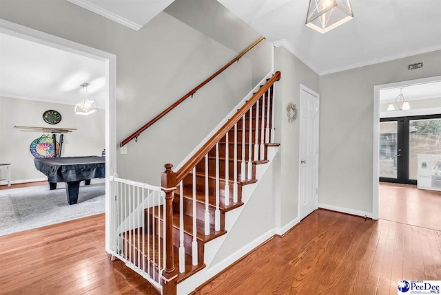 108 Wyandot St, Darlington, SC 29532 - stairway featuring billiards table, hardwood / wood-style floors, ornamental molding, and french doors