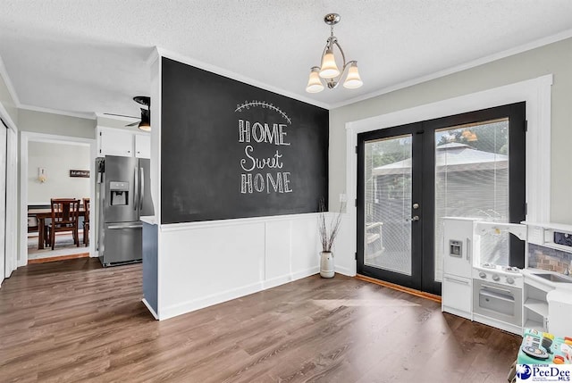 108 Wyandot St, Darlington, SC 29532 - unfurnished dining area with french doors, crown molding, wood finished floors, a textured ceiling, and a chandelier