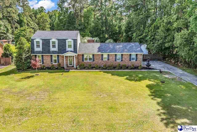 108 Wyandot St, Darlington, SC 29532 - colonial inspired home featuring a shingled roof, brick siding, and a chimney