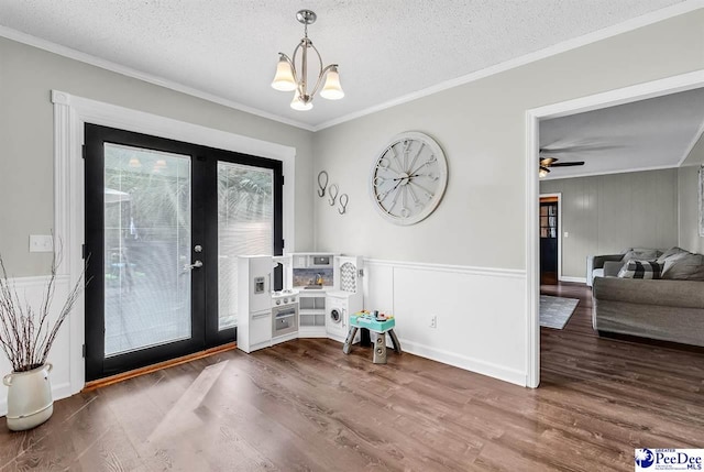 108 Wyandot St, Darlington, SC 29532 - foyer featuring ornamental molding, a chandelier, wood finished floors, a textured ceiling, and a decorative wall