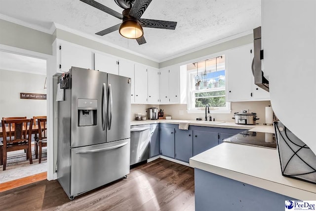 108 Wyandot St, Darlington, SC 29532 - kitchen with stainless steel appliances, ornamental molding, dark wood-style flooring, ceiling fan, and light countertops