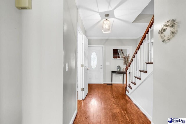 108 Wyandot St, Darlington, SC 29532 - entrance foyer featuring wood finished floors, stairs, and crown molding
