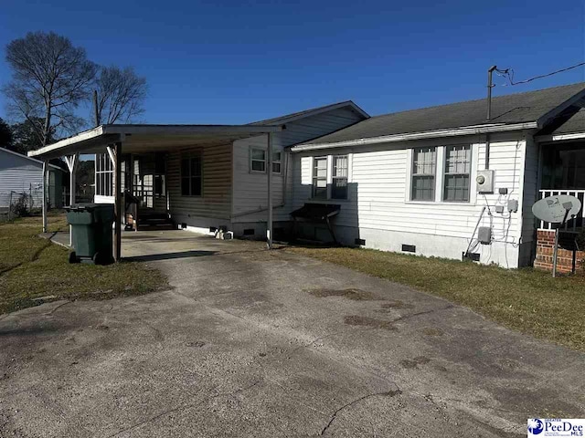 view of front of property with a carport, crawl space, and driveway