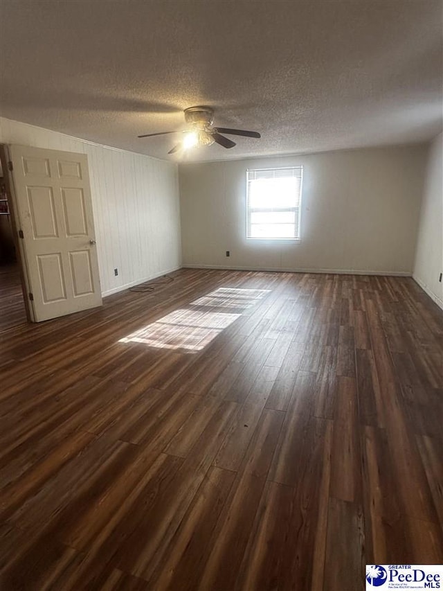 unfurnished bedroom with dark wood-type flooring, a textured ceiling, and a ceiling fan