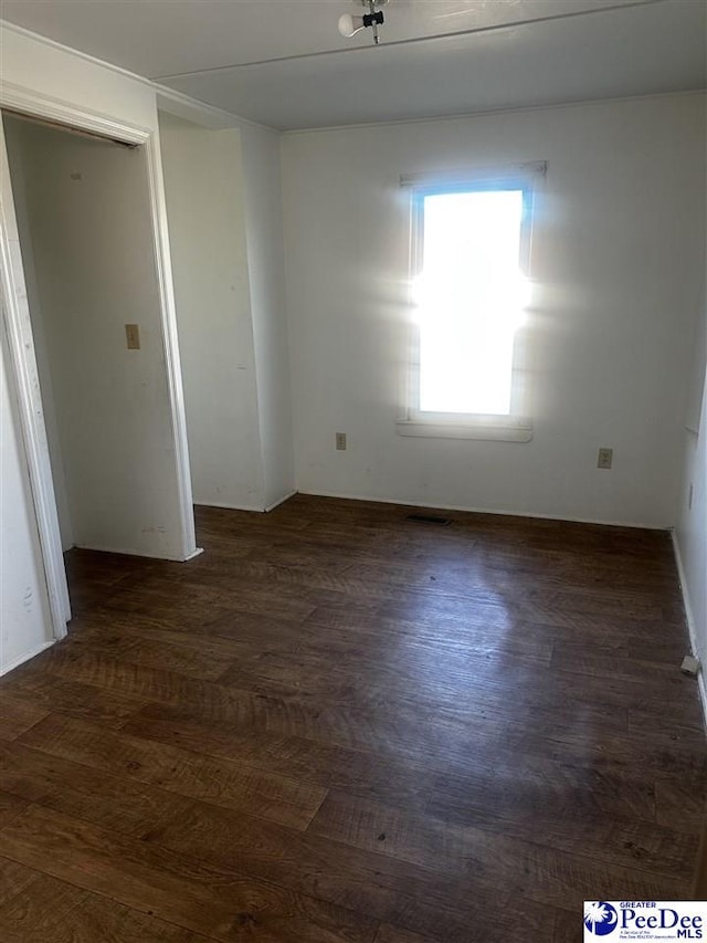 spare room with dark wood-style floors