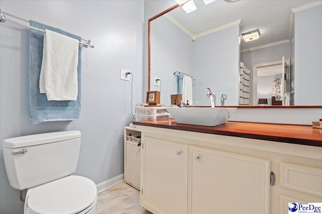 bathroom with vanity, ornamental molding, and toilet