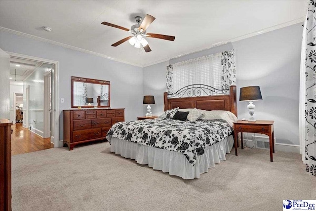 carpeted bedroom featuring crown molding and ceiling fan