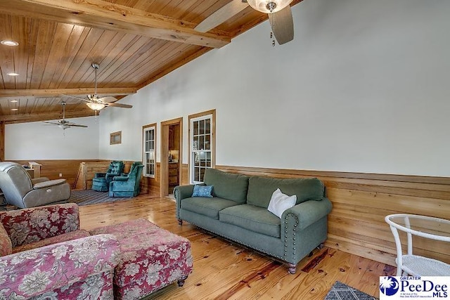 living room with vaulted ceiling with beams, wood ceiling, wood-type flooring, and wooden walls