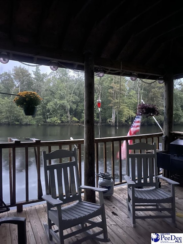 wooden deck featuring a water view