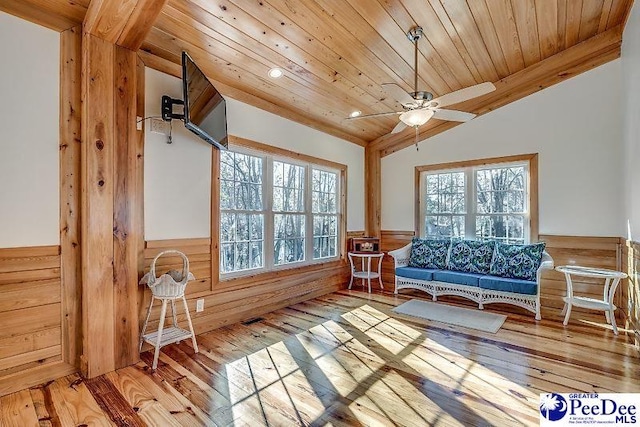 sunroom with vaulted ceiling, wooden ceiling, and ceiling fan