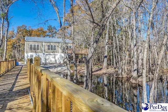 rear view of house featuring a water view