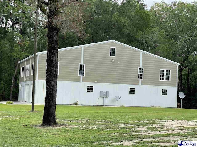 view of side of home featuring a yard