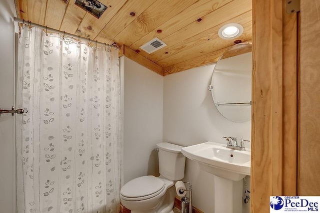 bathroom featuring lofted ceiling, sink, wood ceiling, and toilet