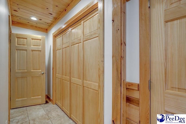 hallway featuring wood ceiling and light tile patterned floors