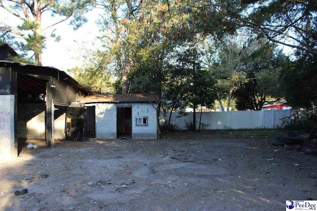 view of outdoor structure featuring fence