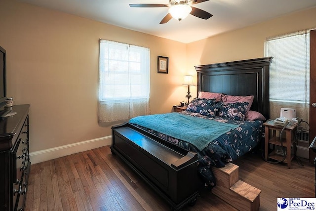 bedroom with ceiling fan, hardwood / wood-style flooring, and baseboards