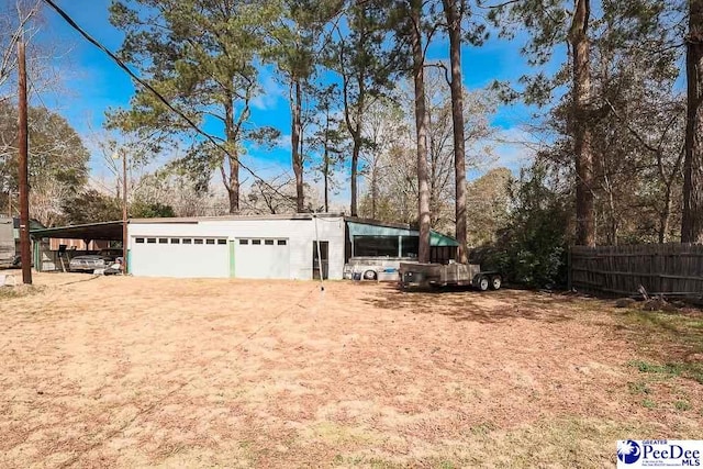 exterior space featuring driveway and fence