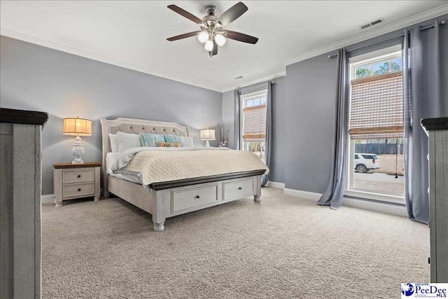 carpeted bedroom with access to exterior, multiple windows, baseboards, and ornamental molding